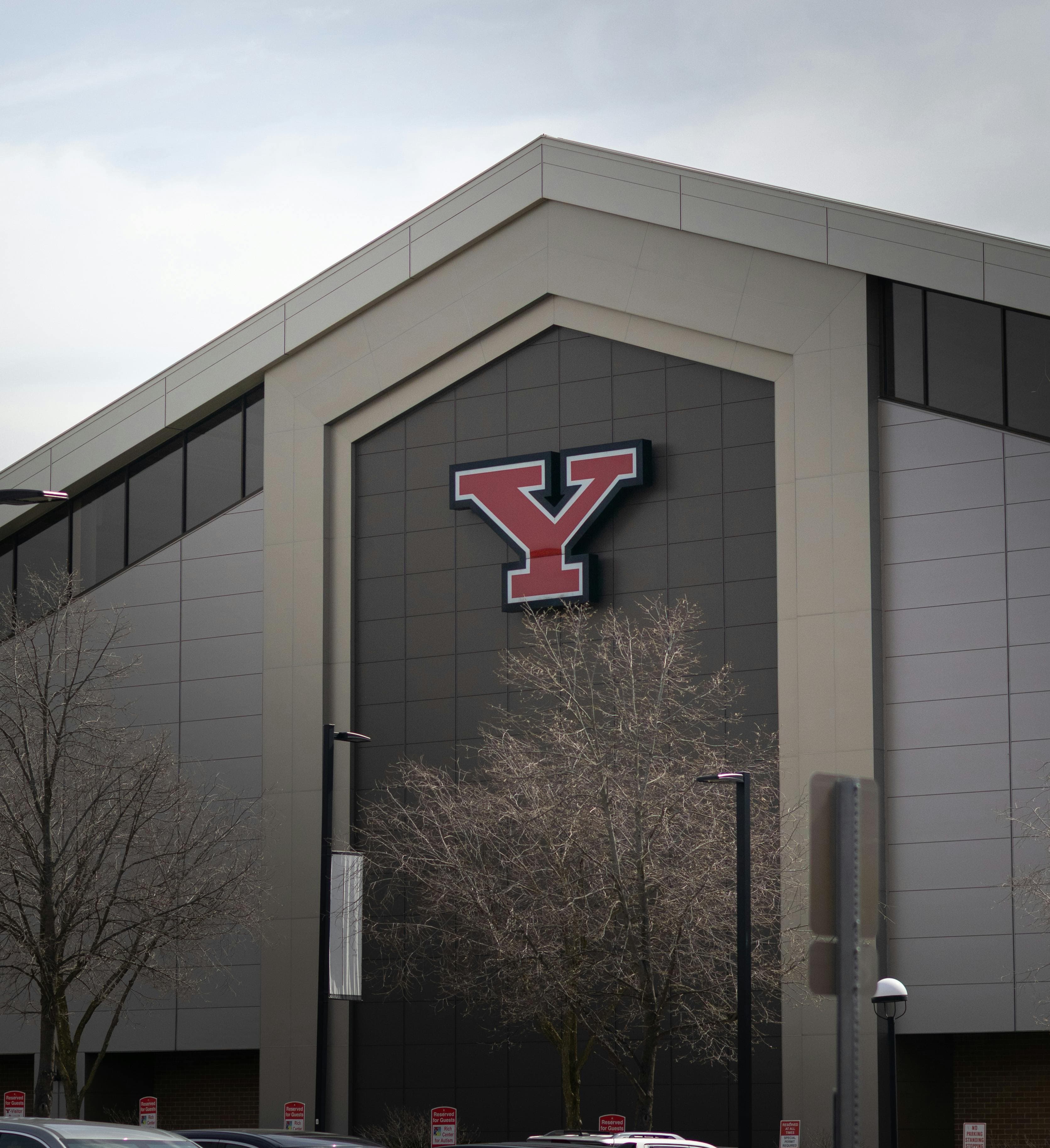 A building exterior featuring a large red letter Y on its facade during a clear day.