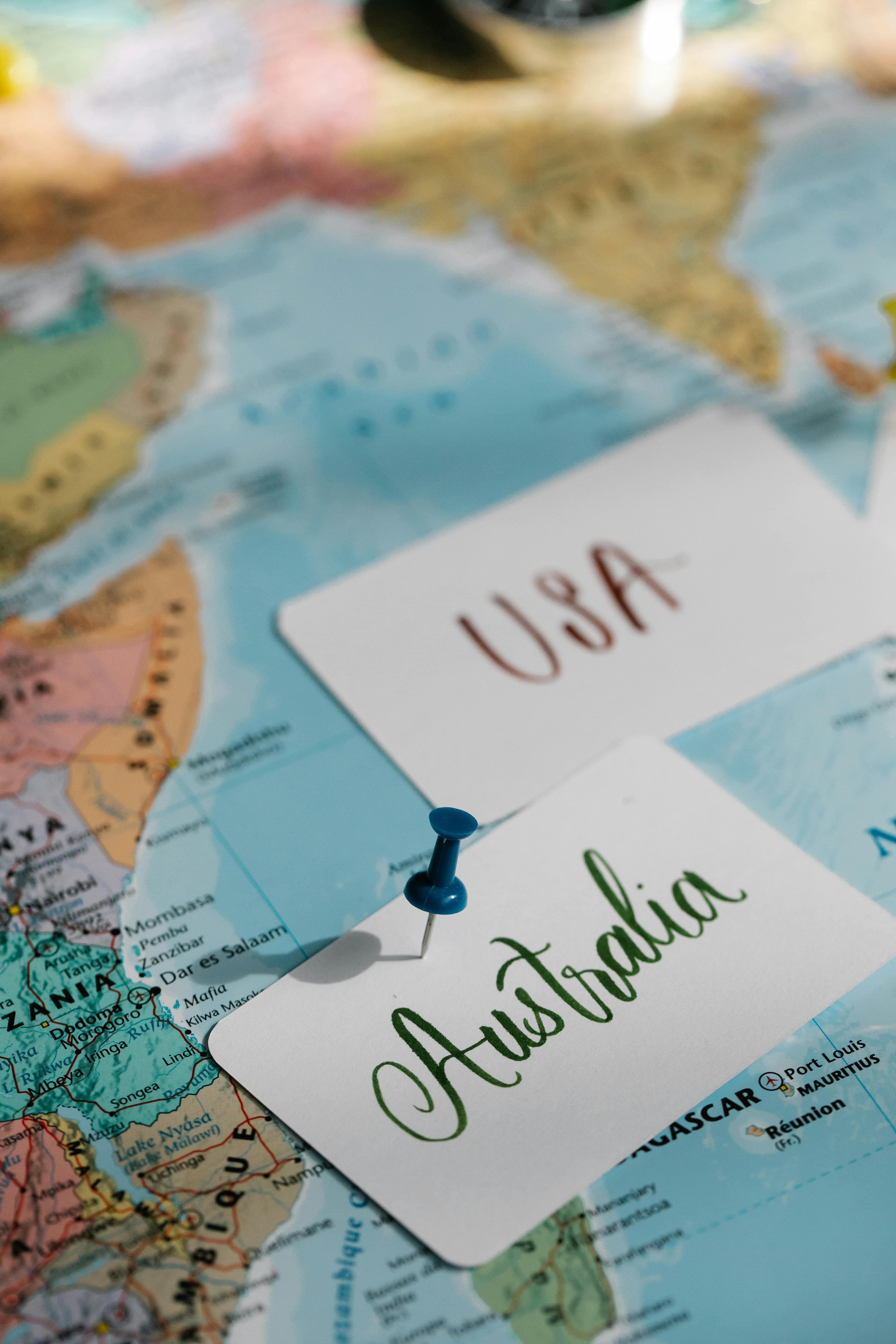 Detailed close-up of a world map with USA and Australia labeled, highlighted with pins.