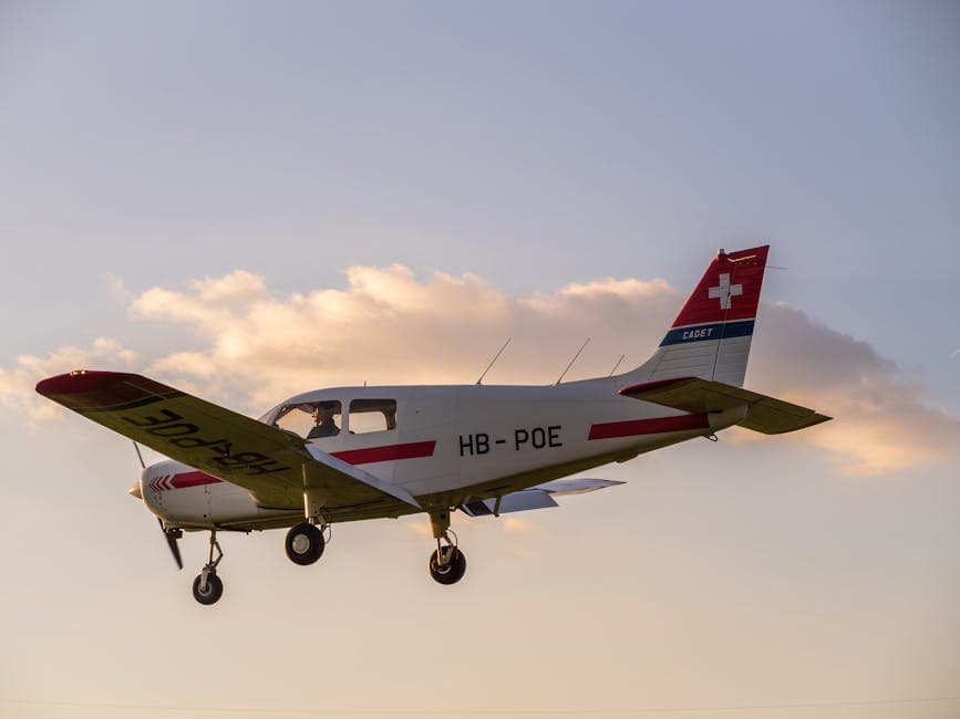 A small single-engine aircraft flying with a backdrop of clouds during sunset, featuring Swiss flag on tail.
