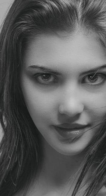 Black and white close-up of a young woman's intense gaze in a classic portrait style.