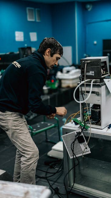 A technician focused on repairing electronic equipment in a laboratory setting.