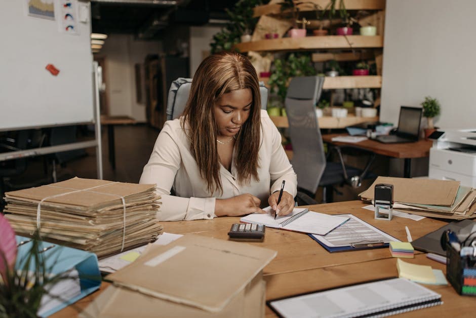 Businesswoman focused on paperwork in an organized office setting.