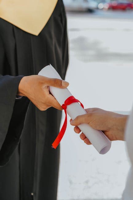 Hands exchanging a graduation diploma wrapped with red ribbon, symbolizing achievement.